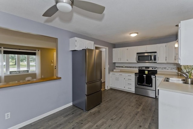 52 Marmon Ct, Springfield, MA 01129 - kitchen with appliances with stainless steel finishes, a sink, white cabinets, and dark wood-type flooring