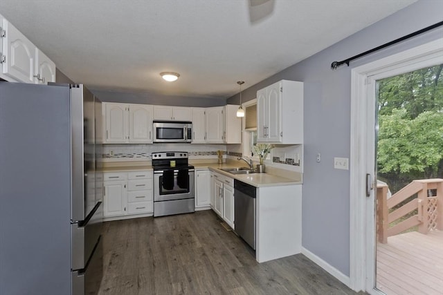 52 Marmon Ct, Springfield, MA 01129 - kitchen with stainless steel appliances, a sink, dark wood-style flooring, white cabinets, and backsplash