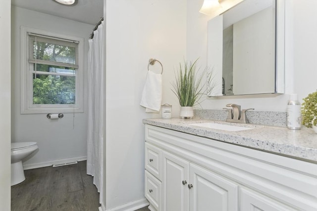 52 Marmon Ct, Springfield, MA 01129 - bathroom featuring vanity, toilet, wood finished floors, and baseboards