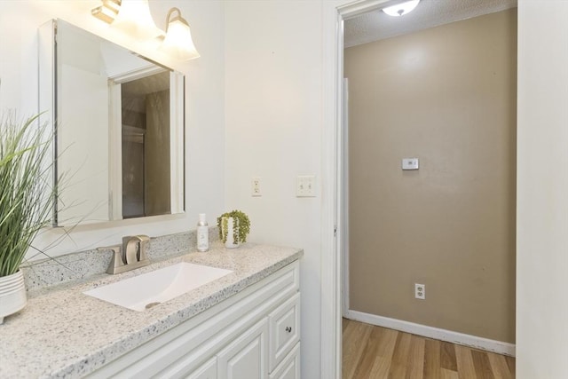52 Marmon Ct, Springfield, MA 01129 - bathroom with vanity, wood finished floors, and baseboards