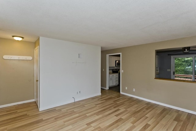 52 Marmon Ct, Springfield, MA 01129 - unfurnished room with light wood-type flooring, baseboards, and a textured ceiling