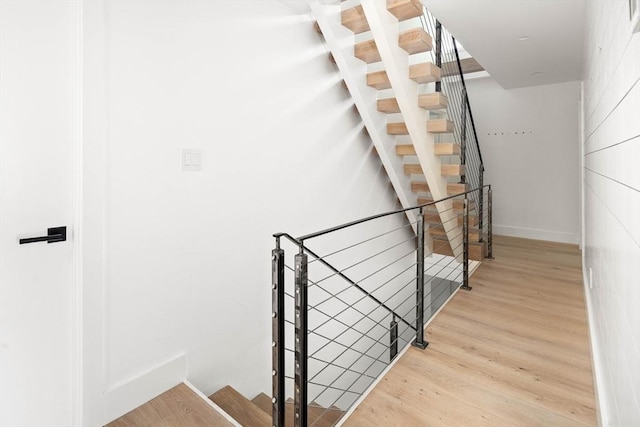 stairs with hardwood / wood-style floors