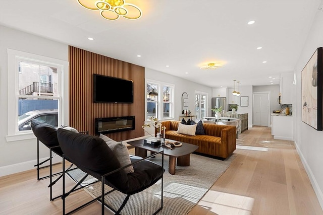 living room featuring plenty of natural light and light hardwood / wood-style flooring