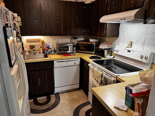 685 Oak St Unit 20-8, Brockton, MA 02301 - kitchen featuring a toaster, white appliances, dark brown cabinets, tasteful backsplash, and under cabinet range hood