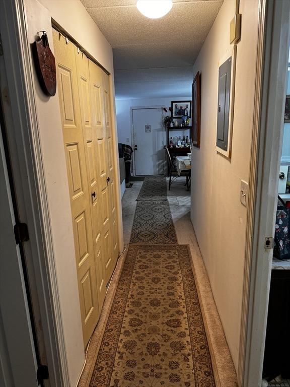 685 Oak St Unit 20-8, Brockton, MA 02301 - hallway with electric panel and a textured ceiling