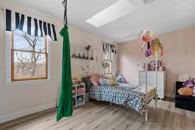 76 Woobly Rd, Bolton, MA 01740 - bedroom featuring wood finished floors, a skylight, and baseboards