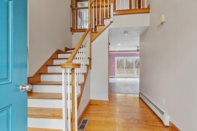 76 Woobly Rd, Bolton, MA 01740 - staircase with a baseboard heating unit, wood finished floors, ceiling fan, and baseboards