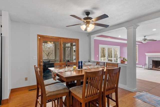76 Woobly Rd, Bolton, MA 01740 - dining room featuring a ceiling fan, a premium fireplace, light wood-type flooring, ornate columns, and recessed lighting