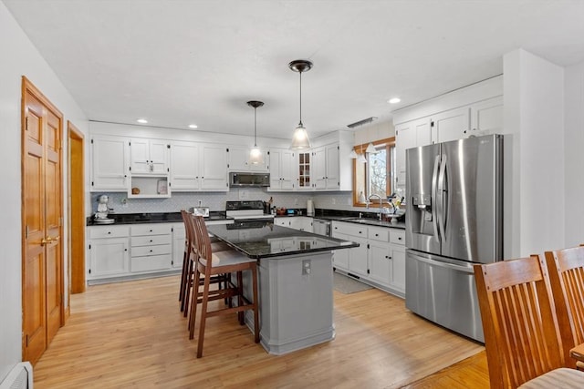 76 Woobly Rd, Bolton, MA 01740 - kitchen with stainless steel appliances, a baseboard radiator, white cabinetry, backsplash, and recessed lighting
