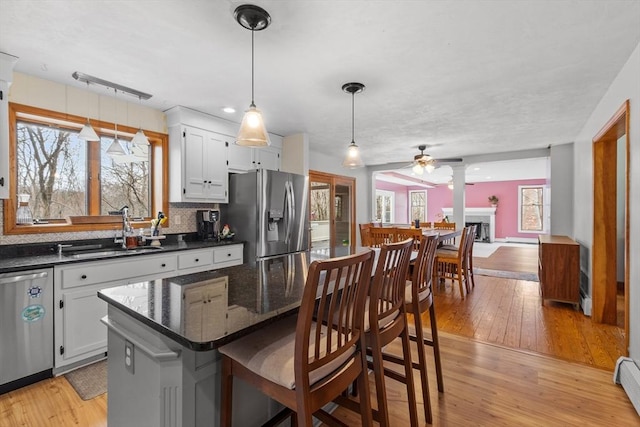 76 Woobly Rd, Bolton, MA 01740 - kitchen with appliances with stainless steel finishes, a sink, ceiling fan, light wood-type flooring, and a baseboard radiator