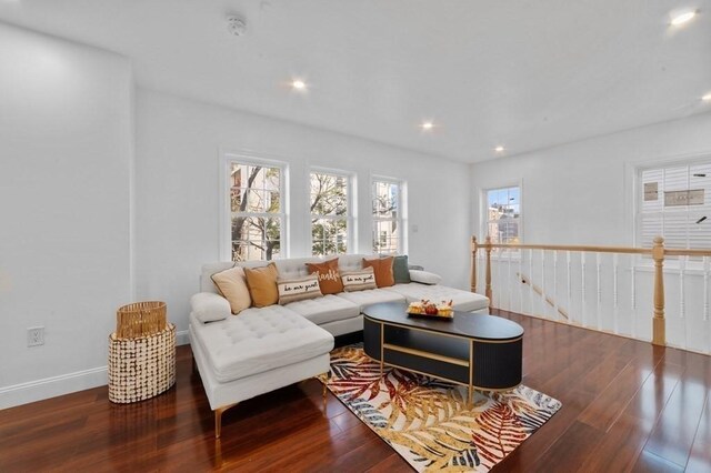 living area with recessed lighting, wood finished floors, and baseboards