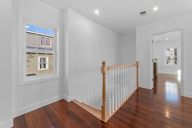 hallway with wood finished floors, recessed lighting, an upstairs landing, and baseboards