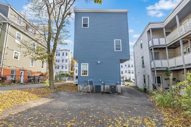 back of property with central AC