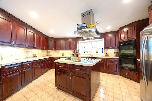 5 Deerfield Rd, Medway, MA 02053 - kitchen featuring reddish brown cabinets, white electric stovetop, light countertops, a kitchen island, and freestanding refrigerator