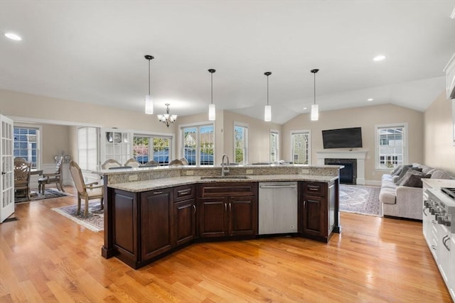 50 Sterling Rd, Needham, MA 02492 - kitchen with a sink, appliances with stainless steel finishes, open floor plan, light wood-style floors, and dark brown cabinets