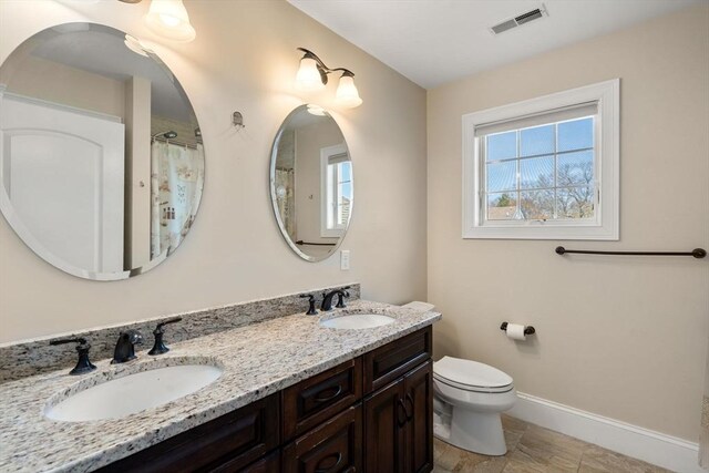 50 Sterling Rd, Needham, MA 02492 - full bathroom with baseboards, toilet, double vanity, and a shower with curtain
