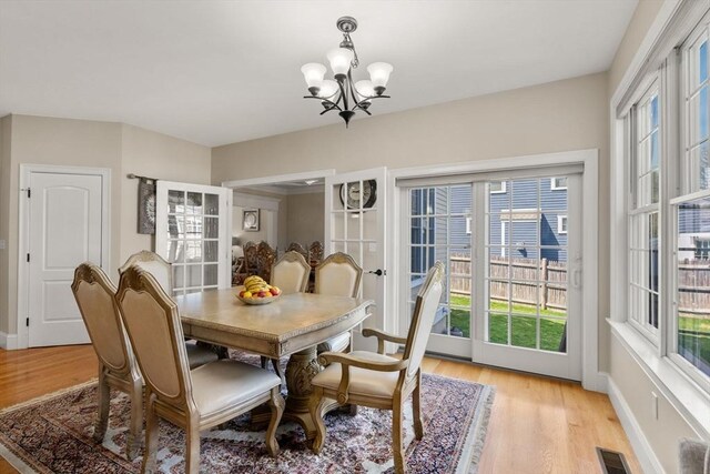50 Sterling Rd, Needham, MA 02492 - dining room with a chandelier, light wood-style flooring, and baseboards