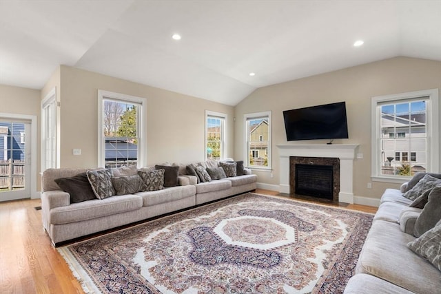 50 Sterling Rd, Needham, MA 02492 - living room with lofted ceiling, light wood-type flooring, a fireplace, recessed lighting, and baseboards