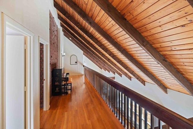 hallway with wooden ceiling, vaulted ceiling with beams, and wood finished floors