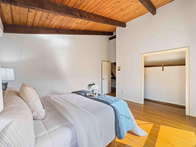 bedroom with wooden ceiling, light wood-style floors, a closet, and beam ceiling