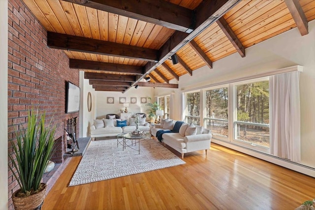 unfurnished living room with lofted ceiling with beams, wood finished floors, brick wall, a fireplace, and wood ceiling