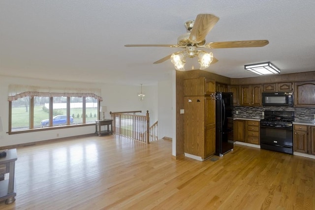 kitchen with decorative backsplash, light wood-style floors, ceiling fan, light countertops, and black appliances