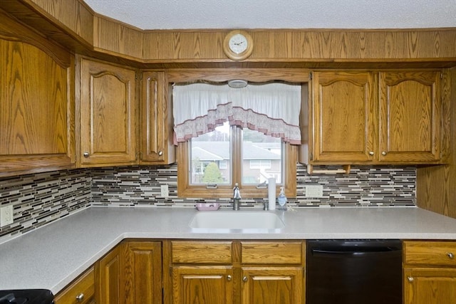 kitchen with light countertops, black dishwasher, brown cabinets, and tasteful backsplash