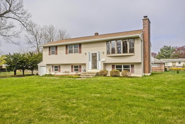 view of front of home with fence, a chimney, and a front lawn