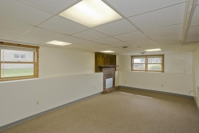 basement with baseboards, carpet, and a paneled ceiling