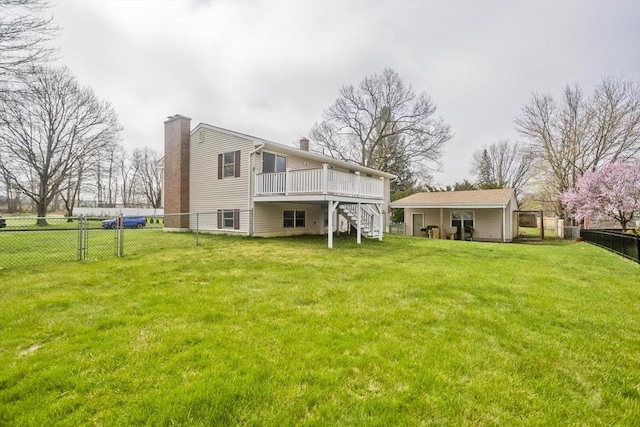 rear view of house featuring a chimney, a wooden deck, stairway, a fenced backyard, and a yard