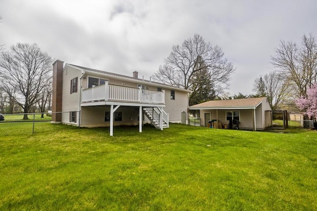 rear view of property featuring a deck, fence, a chimney, and stairs