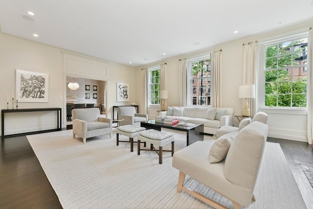 living room featuring built in features, hardwood / wood-style flooring, and ornamental molding