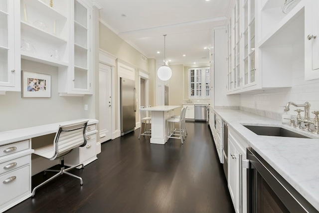 kitchen featuring white cabinetry, pendant lighting, dark hardwood / wood-style flooring, and sink