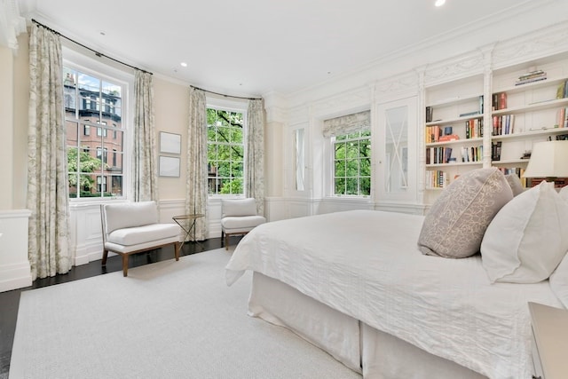 bedroom with wood-type flooring and crown molding