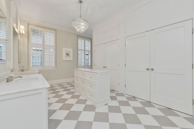 bathroom with double vanity, tile patterned floors, crown molding, and an inviting chandelier