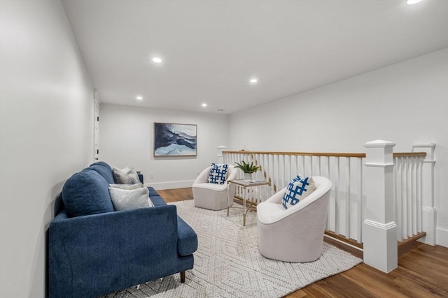 living room featuring recessed lighting, baseboards, and wood finished floors