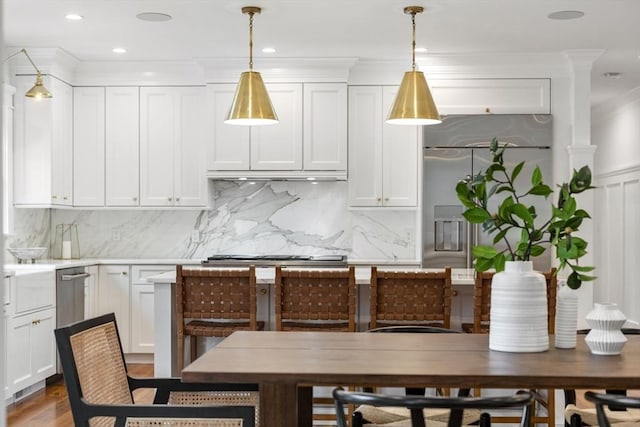 kitchen featuring backsplash, appliances with stainless steel finishes, white cabinets, and light countertops