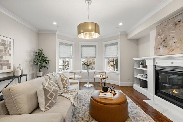 living room with dark hardwood / wood-style flooring, crown molding, and a healthy amount of sunlight