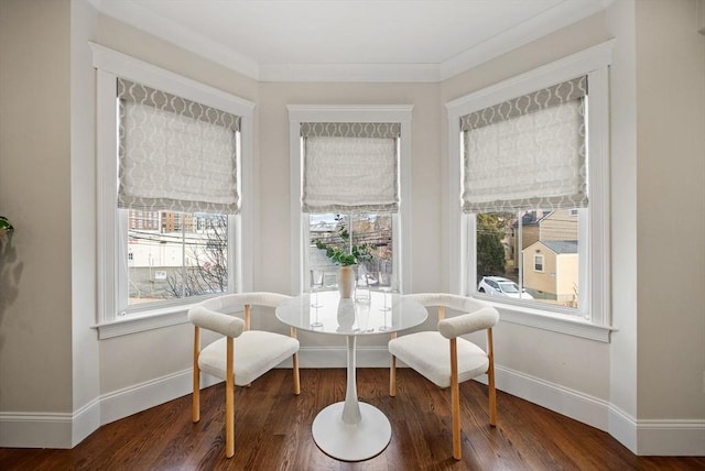 dining space with a wealth of natural light, breakfast area, dark wood-type flooring, and ornamental molding