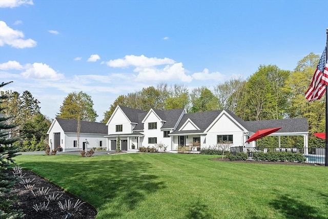 6 Hildreth St, Westford, MA 01886 - rear view of property featuring a lawn