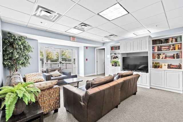 211 Central St Unit A311, Norwood, MA 02062 - living room featuring light carpet, a paneled ceiling, and built in shelves