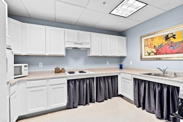 211 Central St Unit A311, Norwood, MA 02062 - kitchen featuring white appliances, under cabinet range hood, a paneled ceiling, white cabinets, and light countertops