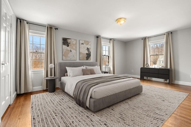 bedroom with baseboards and wood finished floors