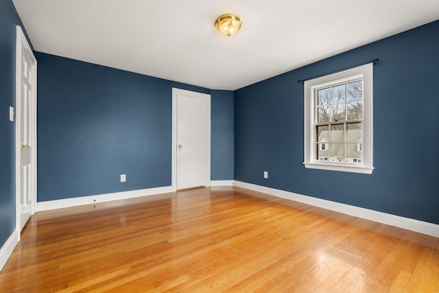 unfurnished bedroom with light wood-type flooring and baseboards