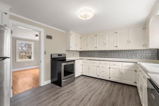 kitchen with tasteful backsplash, visible vents, light wood finished floors, ornamental molding, and appliances with stainless steel finishes