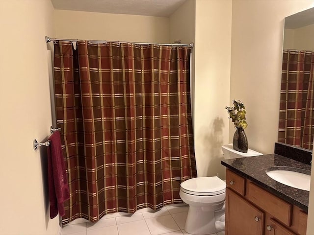 bathroom featuring vanity, tile patterned floors, and toilet