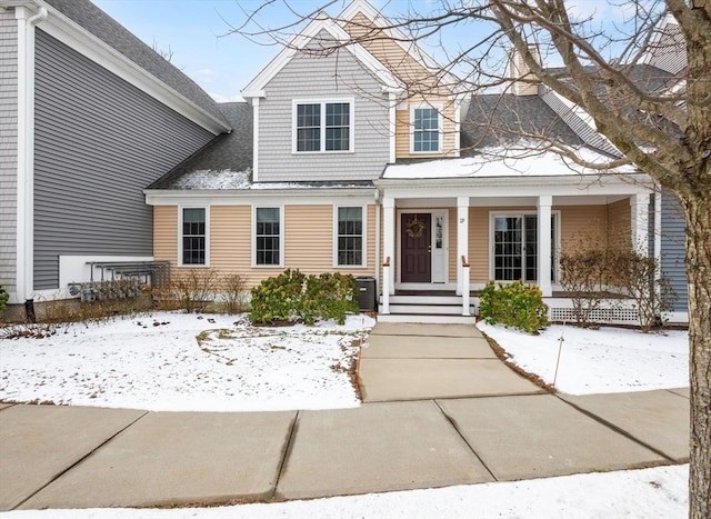 view of front of property featuring a porch and central air condition unit