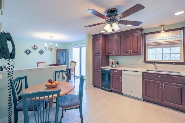 kitchen with ceiling fan with notable chandelier, sink, hanging light fixtures, and dishwasher