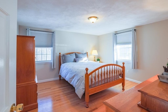 bedroom featuring a textured ceiling and light wood-type flooring