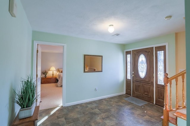 entryway with dark carpet